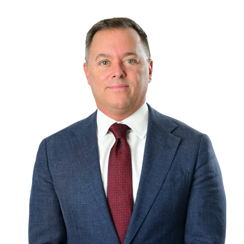 Immigration attorney Dan Williamson wearing a suit and red tie.